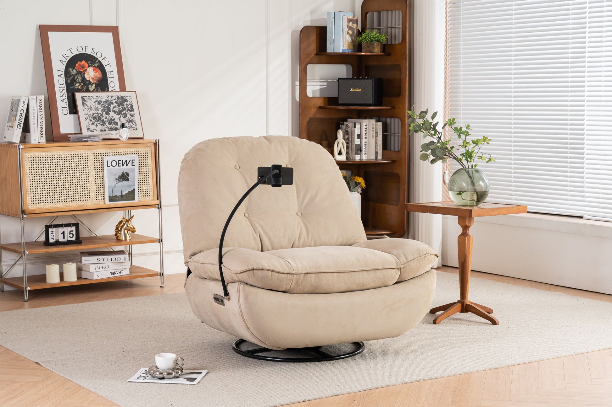 A Power Recliner Swivel Glider with USB charger and Bluetooth music player sits on a rug in a bright living room, next to a small wooden table with a vase and an open bookshelf by the window.