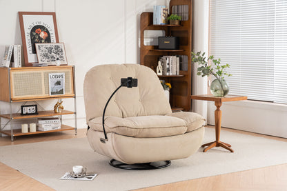 A Power Recliner Swivel Glider with USB charger and Bluetooth music player sits on a rug in a bright living room, next to a small wooden table with a vase and an open bookshelf by the window.