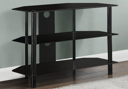 A black, 36-inch TV Stand Console with storage shelves and modern design, placed in a corner on a wooden floor by a white rug and against a light green wall.