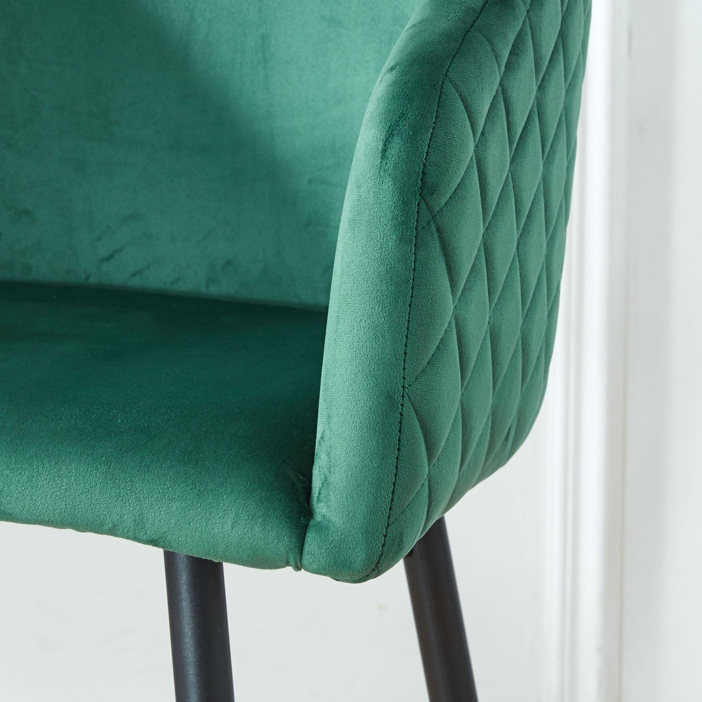 Close-up of a green velvet Counter Height Bar Stool with a quilted diamond backrest and black metal legs, perfect for pub, restaurant, or kitchen island. Set of 2.