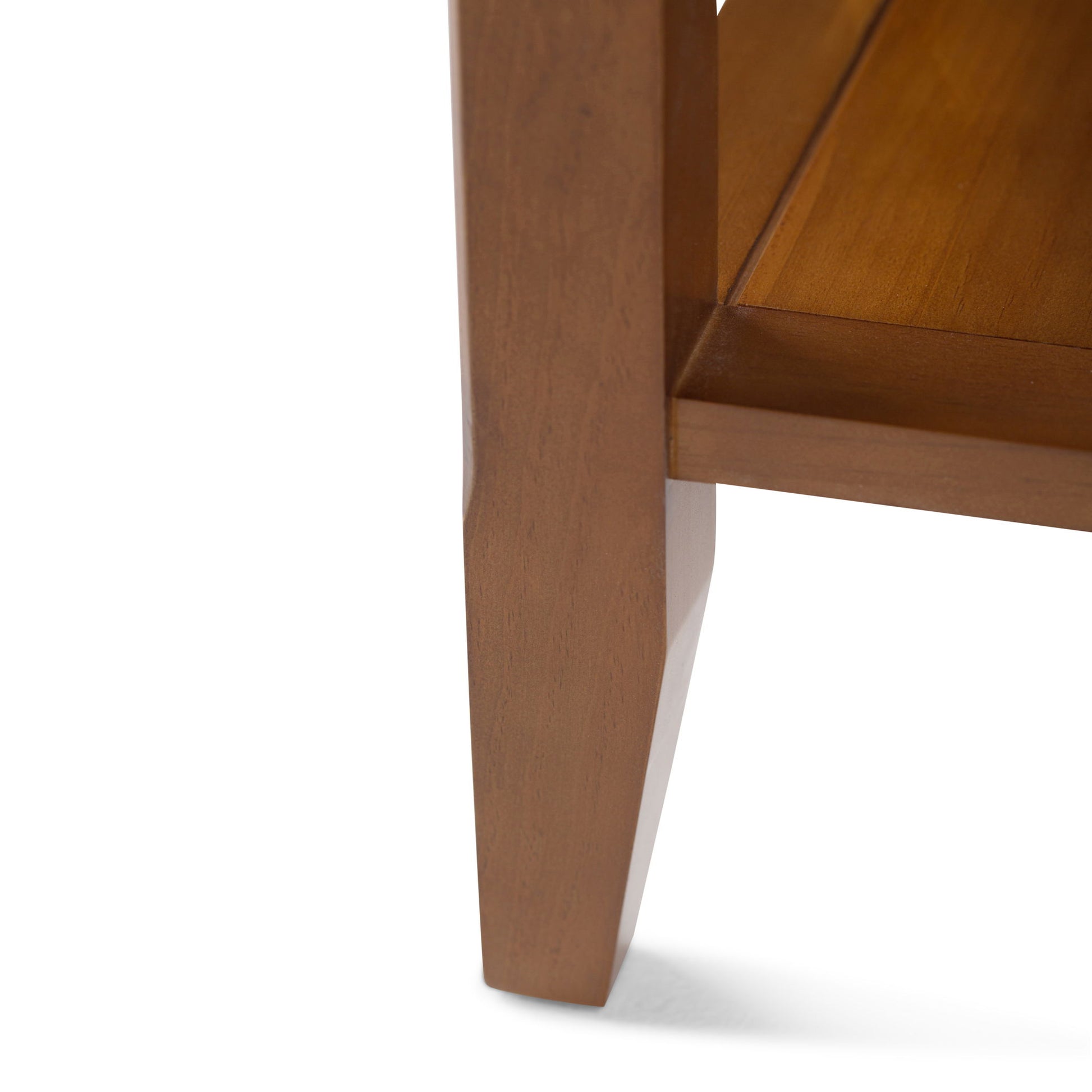 Close-up of the Acadian Handcrafted End Table's leg and lower shelf, highlighting its smooth brown wood finish and simple, clean lines.