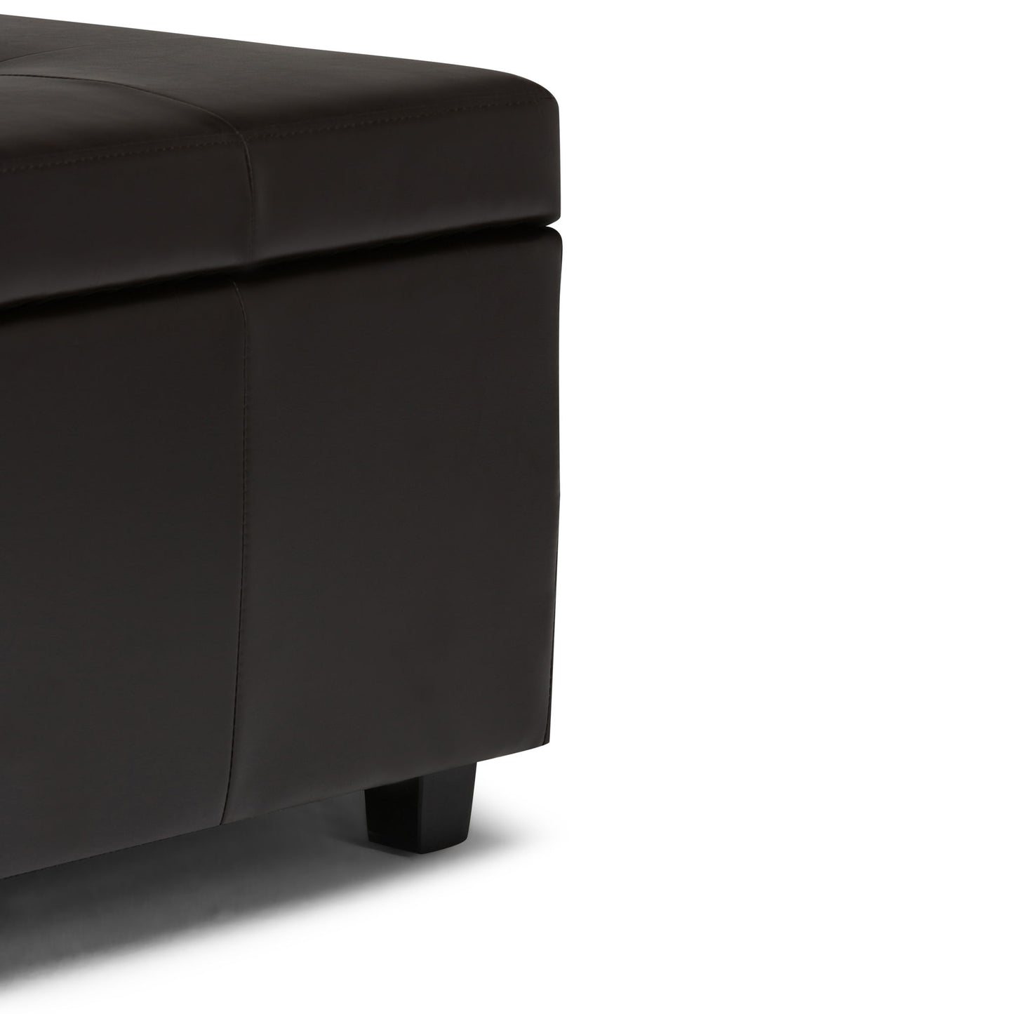 Close-up view of the Castleford - Contemporary Storage Ottoman, featuring dark brown leather upholstery, short black legs, and visible stitching details.