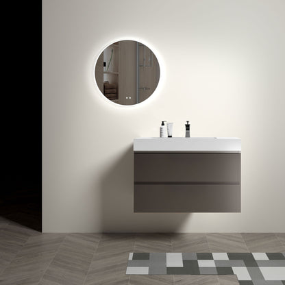 Minimalist bathroom featuring the Alice wall mounted floating vanity with a one-piece sink basin, white countertop, soap dispensers, and a round backlit mirror on a plain wall. Modern geometric floor tiles appear in the foreground.