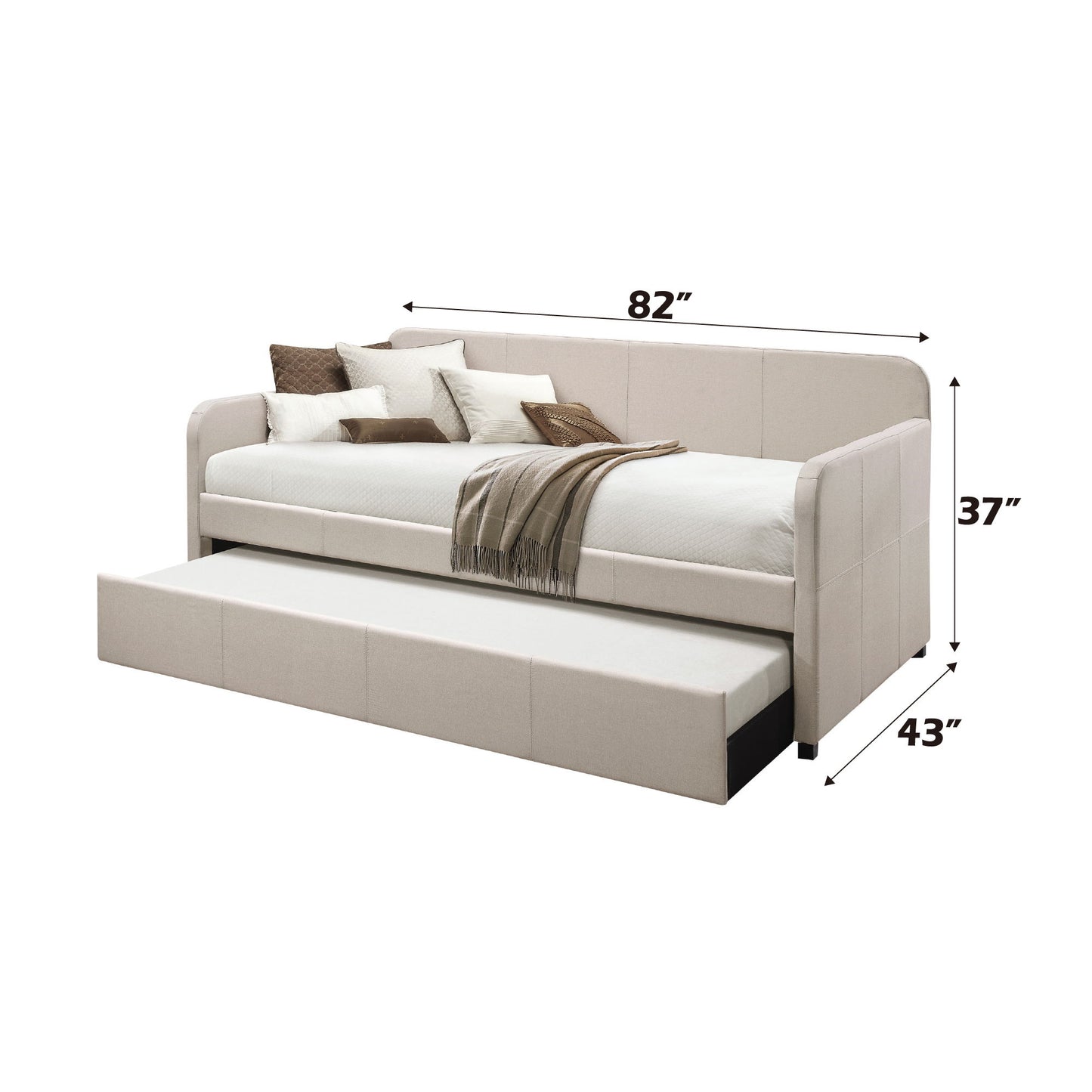 The Jagger - Twin Daybed With Trundle in Fog features a beige upholstered design, includes a pull-out trundle, and measures 82"L x 43"D x 37"H. Shown styled with pillows and a brown throw blanket.