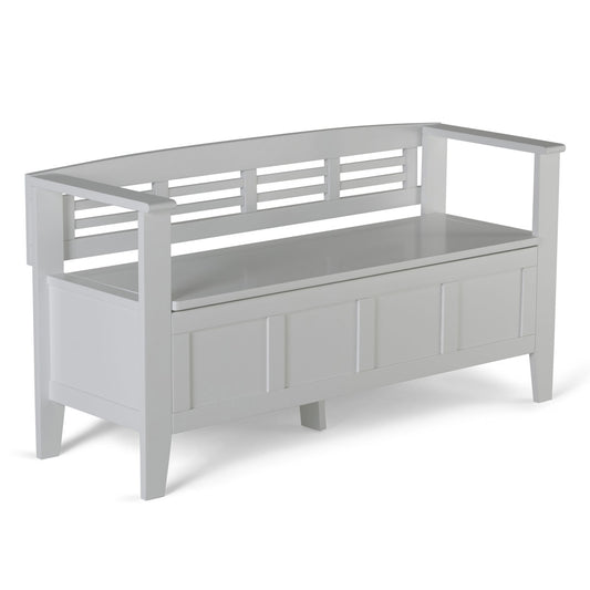 The Adams - Entryway Storage Bench Handcrafted features a white wooden frame, slatted backrest, open armrests, a paneled front design, and a storage compartment beneath the seat.