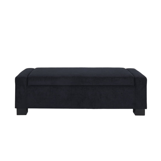 The Textured Fabric Ottoman Bench With Hinged Lid features a rectangular black upholstered design, a cushioned top, and short block-style legs, shown against a white background.