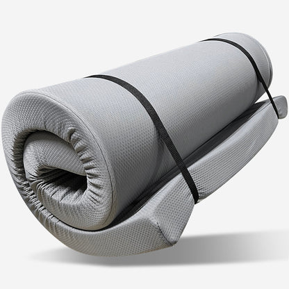 The Memory Foam Camping Mattress features a gray, rolled-up design with a water-resistant cover and is secured by two black adjustable straps, perfect for portable comfort.