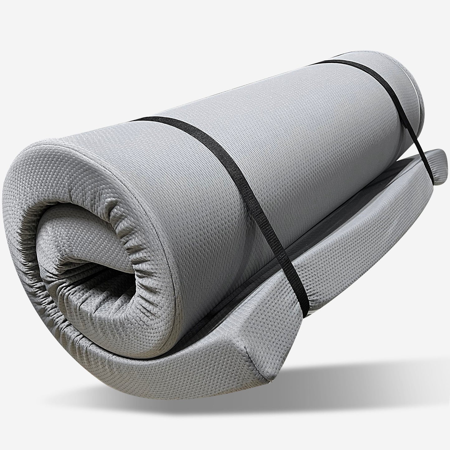 The Memory Foam Camping Mattress Foldable in gray is shown rolled up, secured with two black straps, against a plain white background. Portable and water resistant, it’s ideal for camping or travel.
