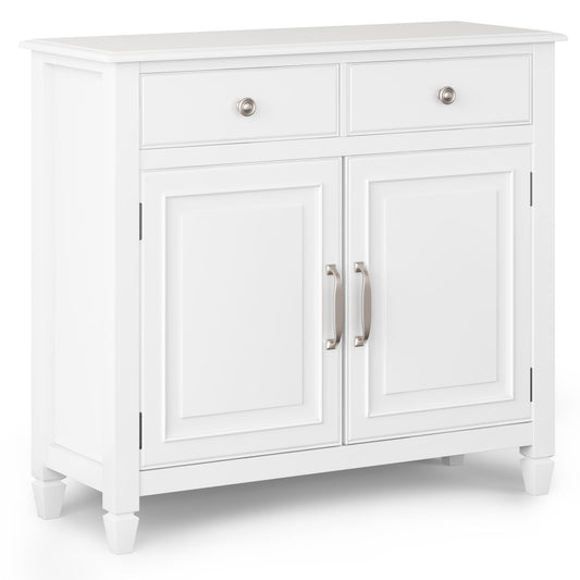 The Connaught Handcrafted Entryway Storage Cabinet is a white wooden piece with two upper drawers, two lower doors, silver handles and knob pulls, and stands on four short legs.