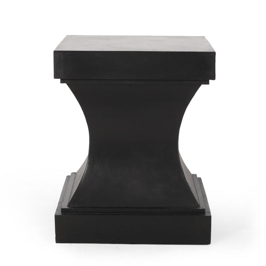 The Athena - Modern Side Table With Pedestal Design features a matte black square top and base, a concave hourglass-shaped center, and smooth minimalist surfaces, all set against a plain white background.