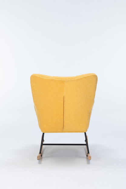 The Rocking Chair Nursery is a yellow upholstered glider rocker with a high curved backrest, black metal legs, and wooden rockers, shown from behind on a plain white background.