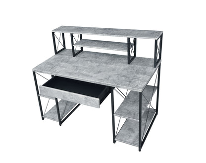 The Amiel - All Purpose Writing Desk is a modern gray desk with a metal frame, a raised shelf, pull-out center drawer, and multiple side shelves for storage, pictured against a white background.