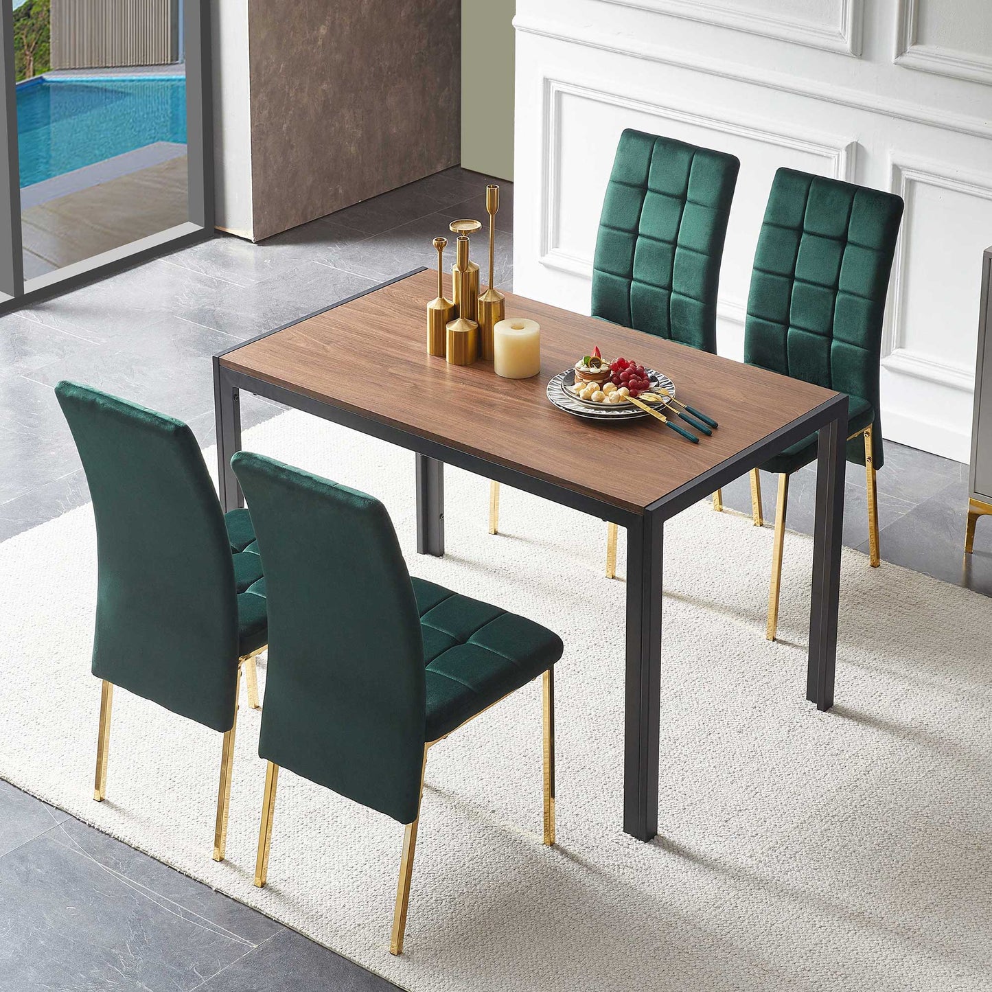 A 5-piece dining set features a creative design table and four velvet high-back chairs with gold legs, arranged on a light rug. The table displays candles, gold decor, and a plate of food with chopsticks.
