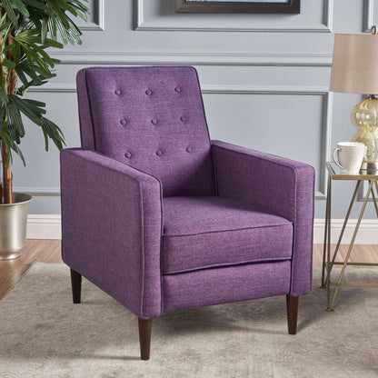 A Mid-Century Modern Recliner with button tufted waffle stitch sits on a light rug in a stylish living room, accompanied by a small side table, potted plant, and lamp.
