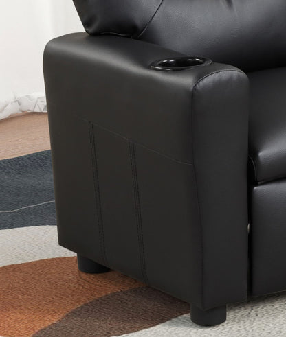 The image shows the armrest of the Marisa - PU Leather Kids Recliner Chair with a built-in cupholder. The chair features short round legs, and part of a colorful patterned rug is visible on the floor.