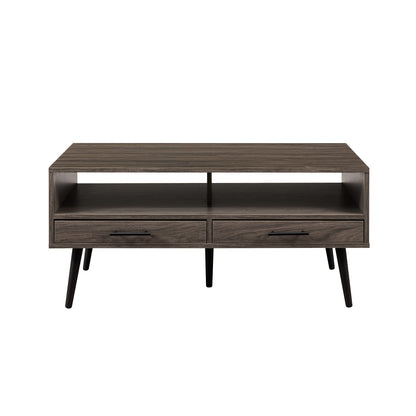 The Contemporary 2 Drawer Low Coffee Table features a modern rectangular design with two drawers, an open shelf above them, four angled black legs, a dark wood finish, and a minimalist style.