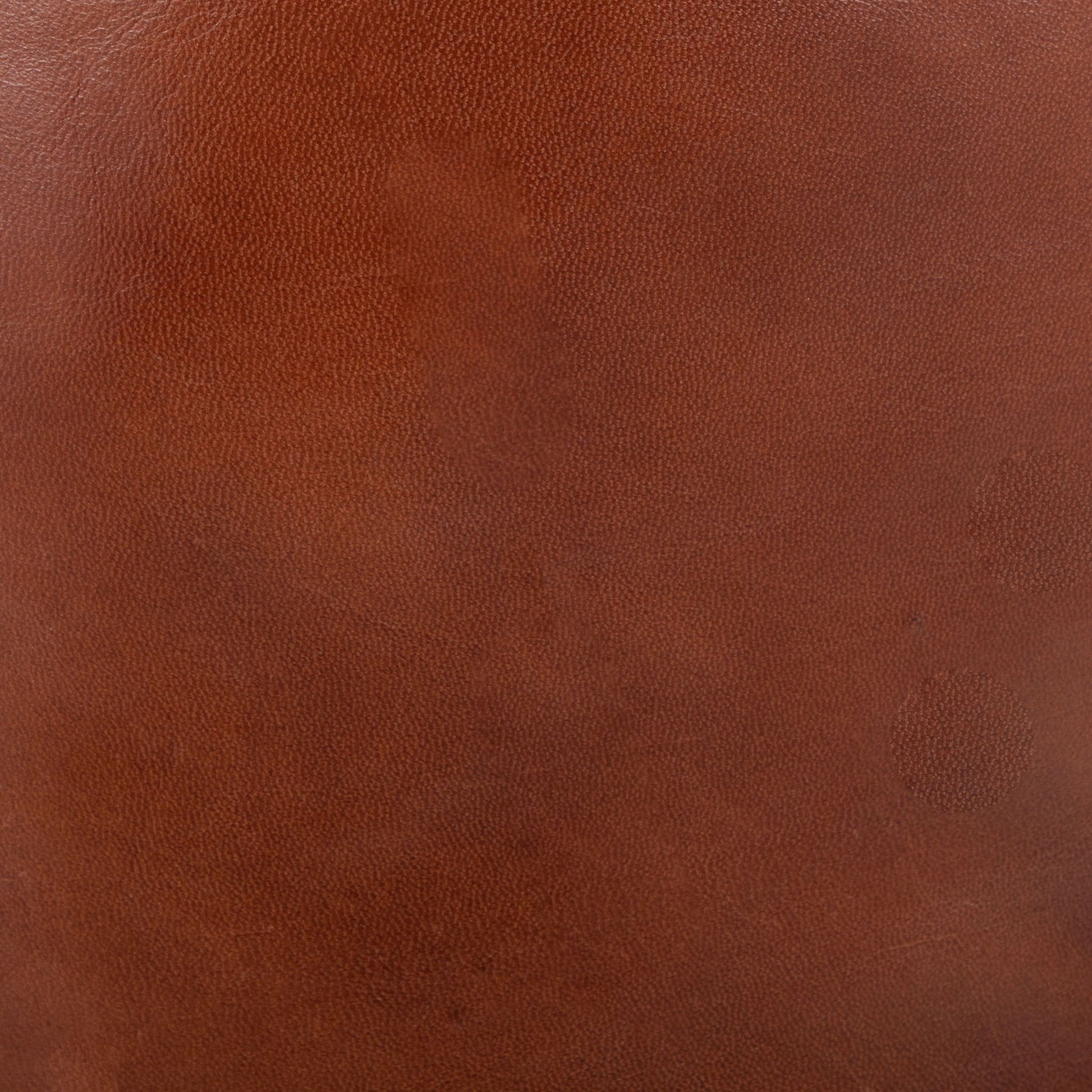 Close-up of the Cobbler - Industrial High Quality Pouf in brown, featuring smooth leather with subtle texture, fine grain, and natural color variations.