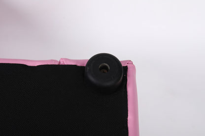 Close-up of the corner of the Kids Club Chair Sofa / Sectional And Ottoman - Pink, showing black plastic or rubber foot attached to pink and black fabric upholstery against a white background.