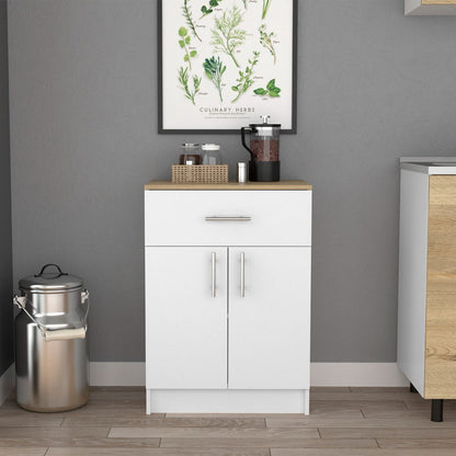 A white Pantry Organizer Cabinet with a light oak top, featuring one drawer, two shelves, and two doors, stands against a gray wall beneath a framed botanical print. A stainless steel milk can sits on the floor to the left.