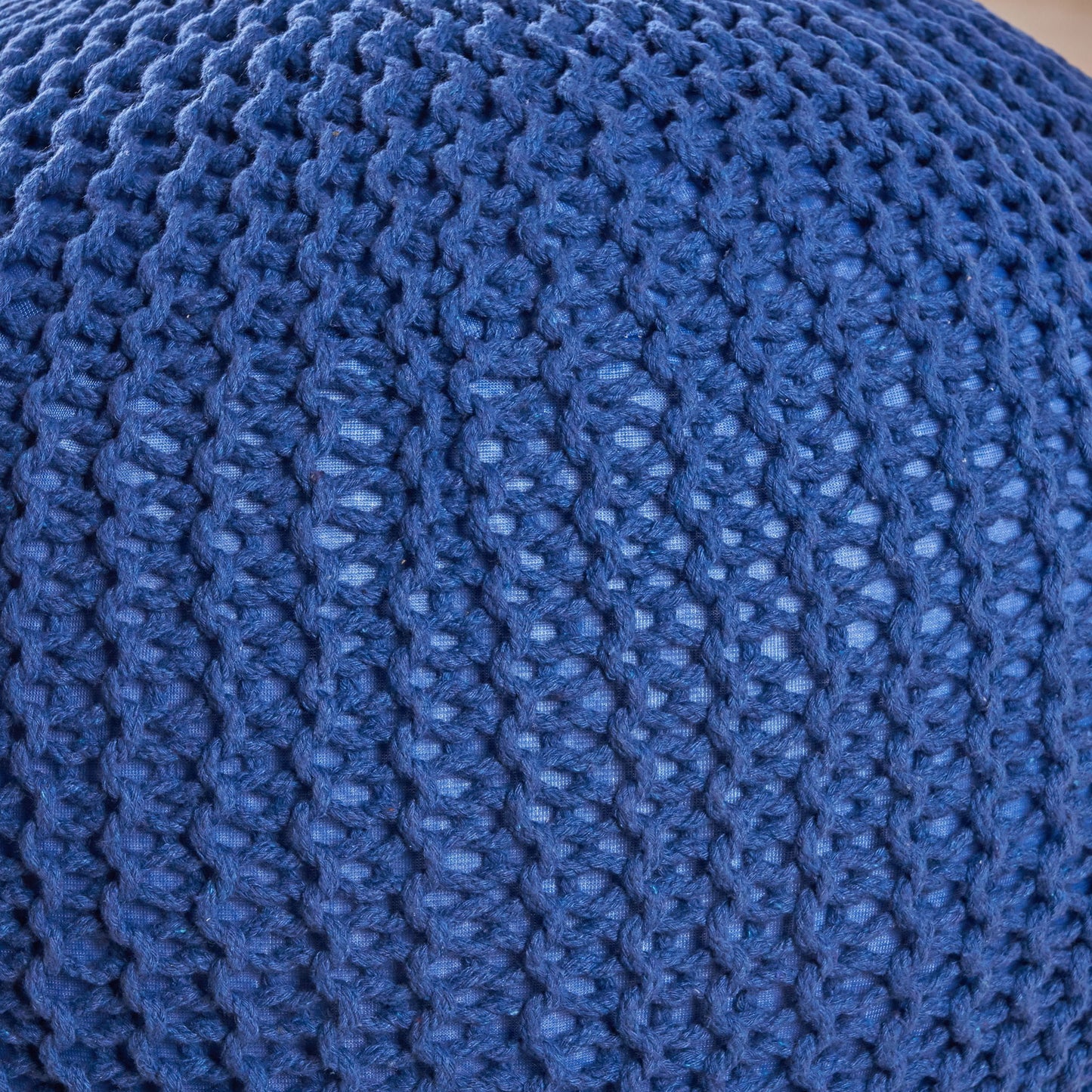Close-up of the Bordeaux Knitted Cotton Round Pouf, showcasing its blue textured fabric and repeating pattern of raised stitches—ideal as a versatile ottoman or floor cushion.