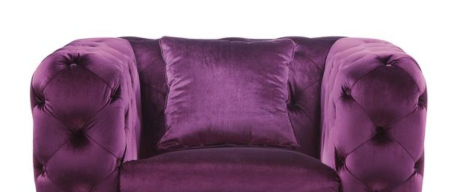 The Atronia - Chair features elegant design in deep purple velvet, tufted armrests, and comes with a matching pillow, shown from the front against a white background.