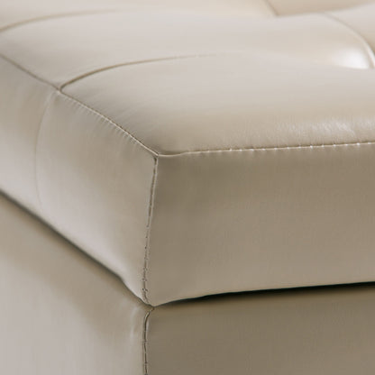 Close-up of the Cosmopolitan - Upholstered Storage Ottoman in beige leather, featuring visible stitching, tufted details, and a matching base.