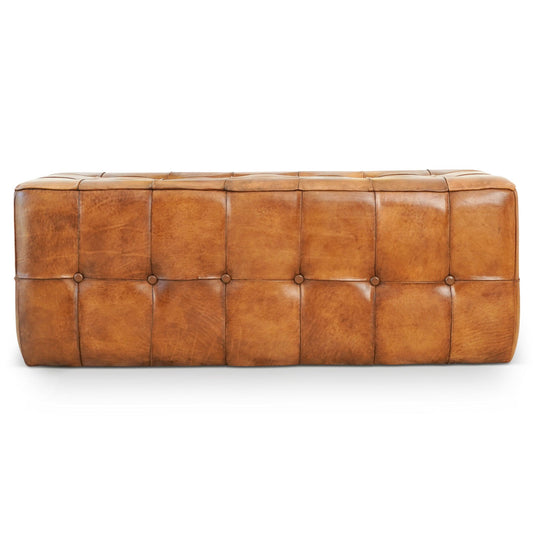 The Benjiro Bench in tan features a rectangular tufted design with visible stitching and button details, upholstered in caramel brown leather and set against a white background.