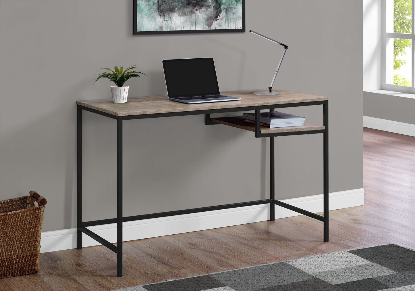 A Computer Desk For Home Office with a compact modern design and contemporary style features a wood top and black metal frame against a gray wall, with a laptop, desk lamp, potted plant, and natural light from a nearby window.
