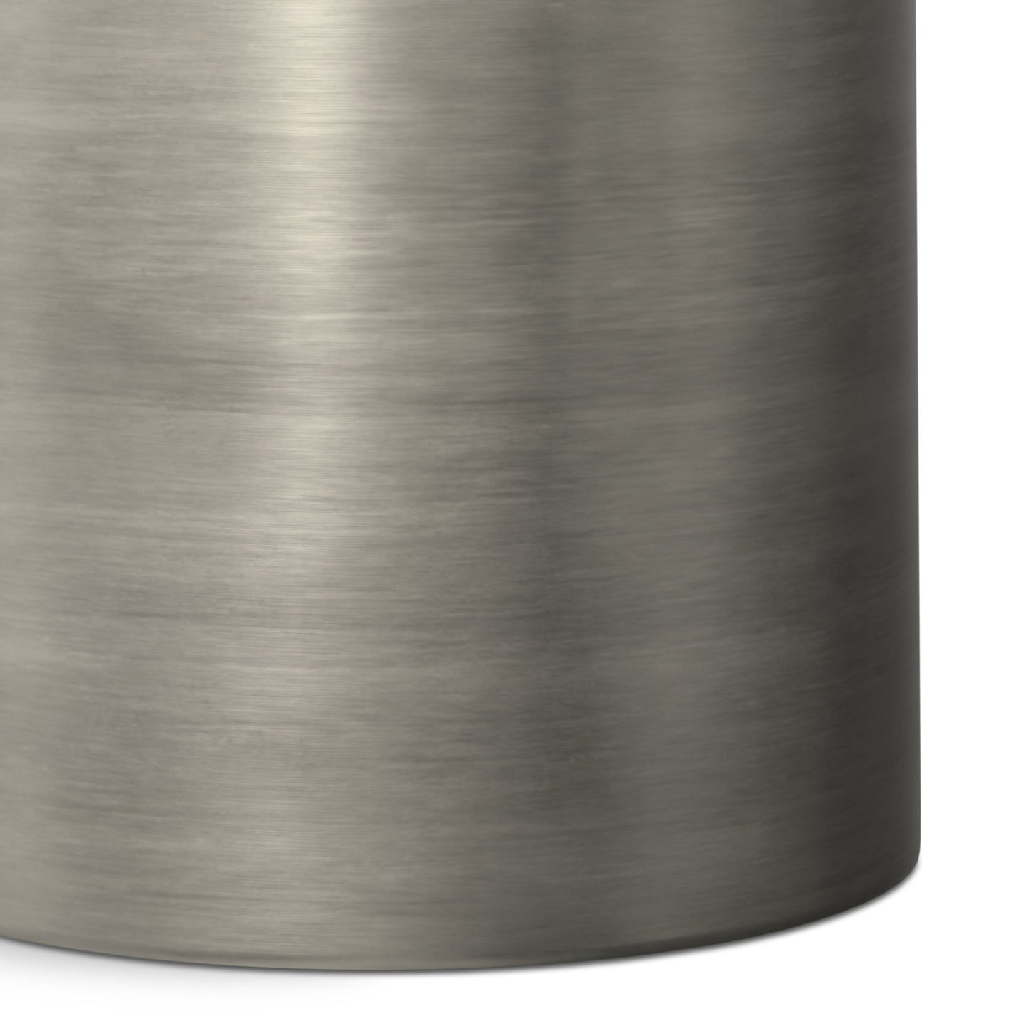 Close-up of the Corbin Handcrafted Metal Side Table in brushed stainless steel, highlighting its smooth metallic texture and rounded right edge.