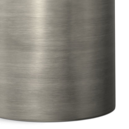 Close-up of the Corbin Handcrafted Metal Side Table in brushed stainless steel, highlighting its smooth metallic texture and rounded right edge.