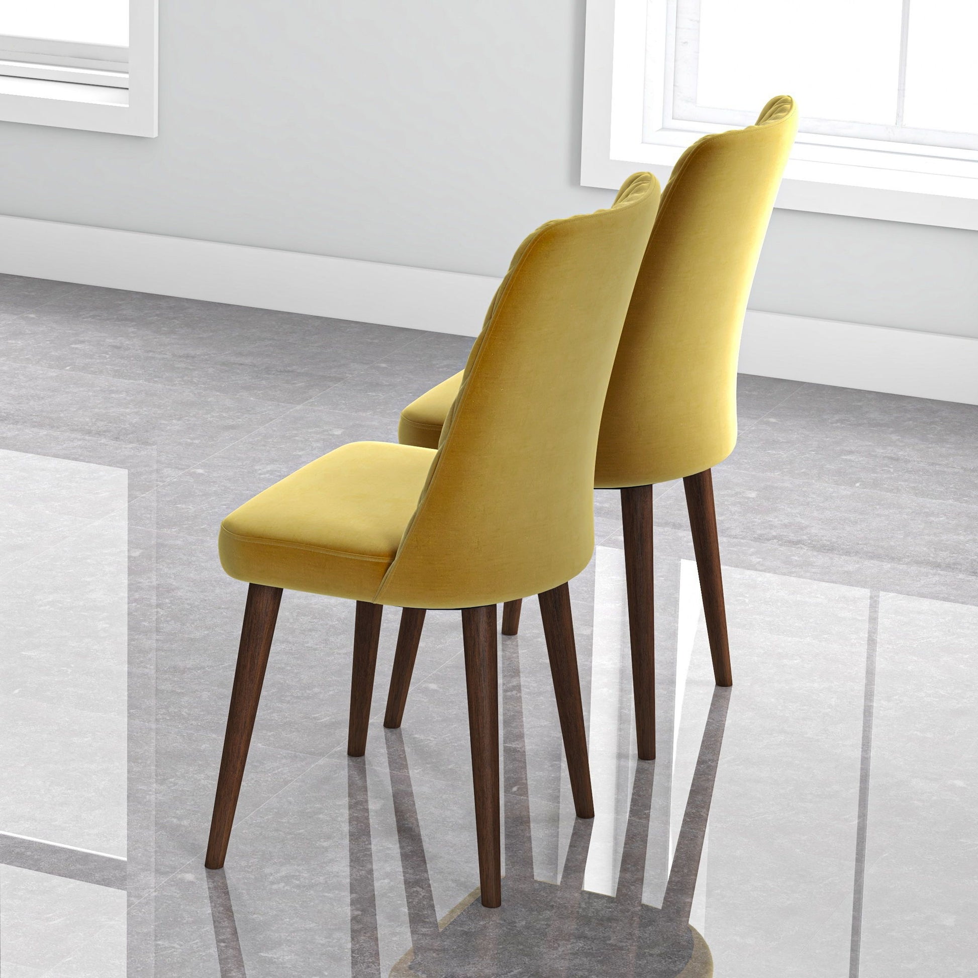 Two Katie Mid-Century Modern Dining Chairs (set of 2) with yellow upholstery and wooden legs are placed side by side on a shiny gray tiled floor near a white wall and a window with natural light.