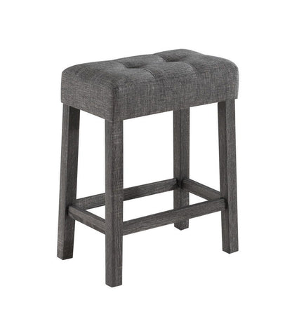 The Lux 3 Piece Counter Height Pub Table set features modern gray tufted linen stools with cushioned seats and dark wood legs connected by support bars.