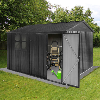 A 10' x 8' Garden Sheds Outdoor Storage Sheds With Window stands on a grassy lawn surrounded by trees, its open doors revealing a bicycle, ladder, folded table, and green watering can inside.