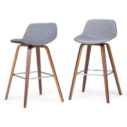 The Randolph Bentwood Counter/Bar Height Stools (Set of 2) feature grey cushioned seats, curved backrests, angled walnut-finished wooden legs, and metal footrests for added support.