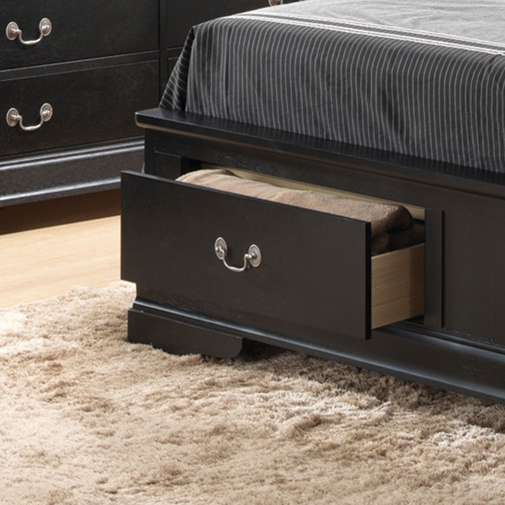The Louis Phillipe - Storage Bed features a dark wooden frame with a built-in drawer, shown open to reveal a folded blanket. The bed is dressed in a striped gray bedspread and sits atop a beige shaggy rug, with a matching dresser nearby.