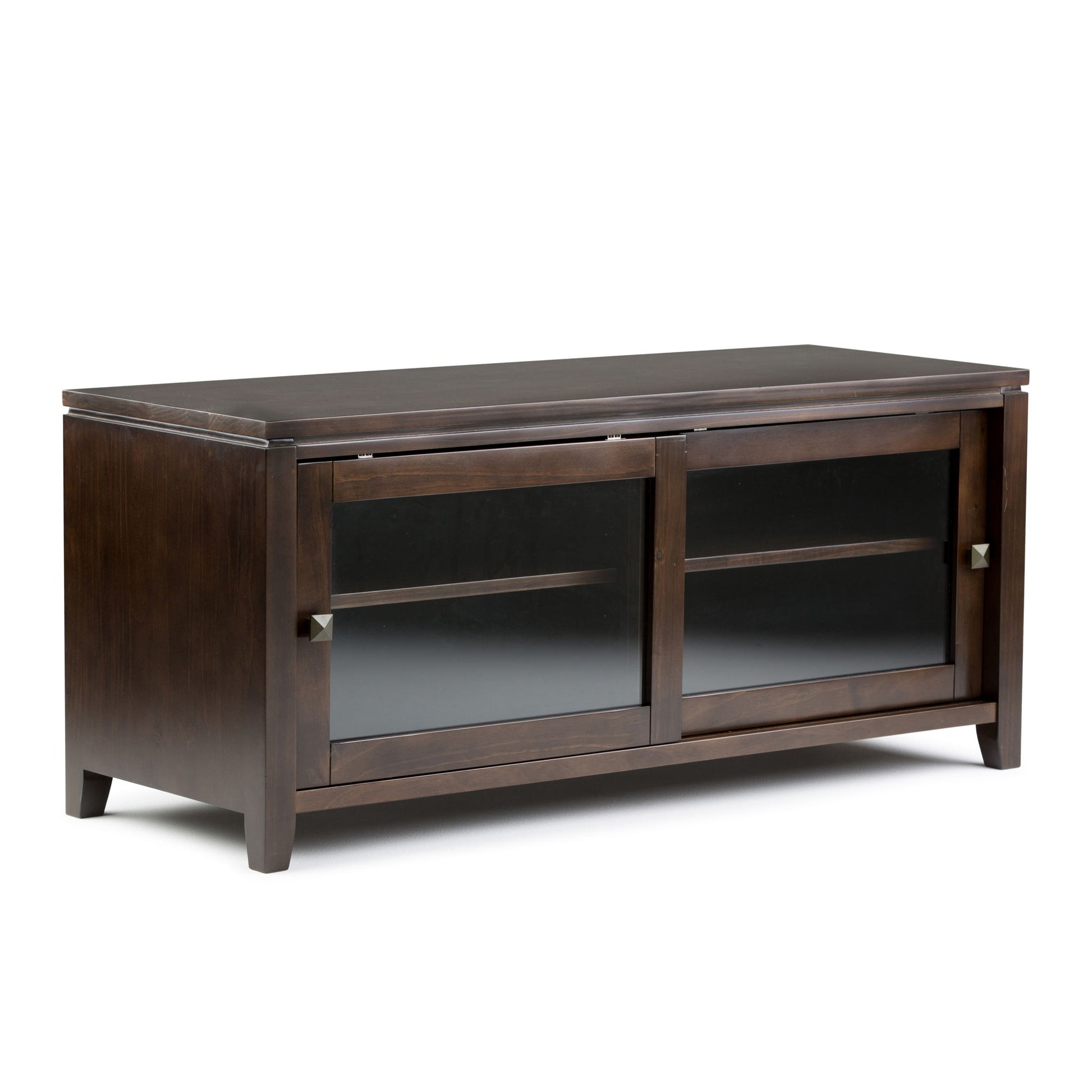 The Cosmopolitan Handcrafted TV Media Stand features dark wood, two sliding glass doors with square metal handles, an interior shelf, and short legs. Its modern, simple design is ideal for any living room or media setup.