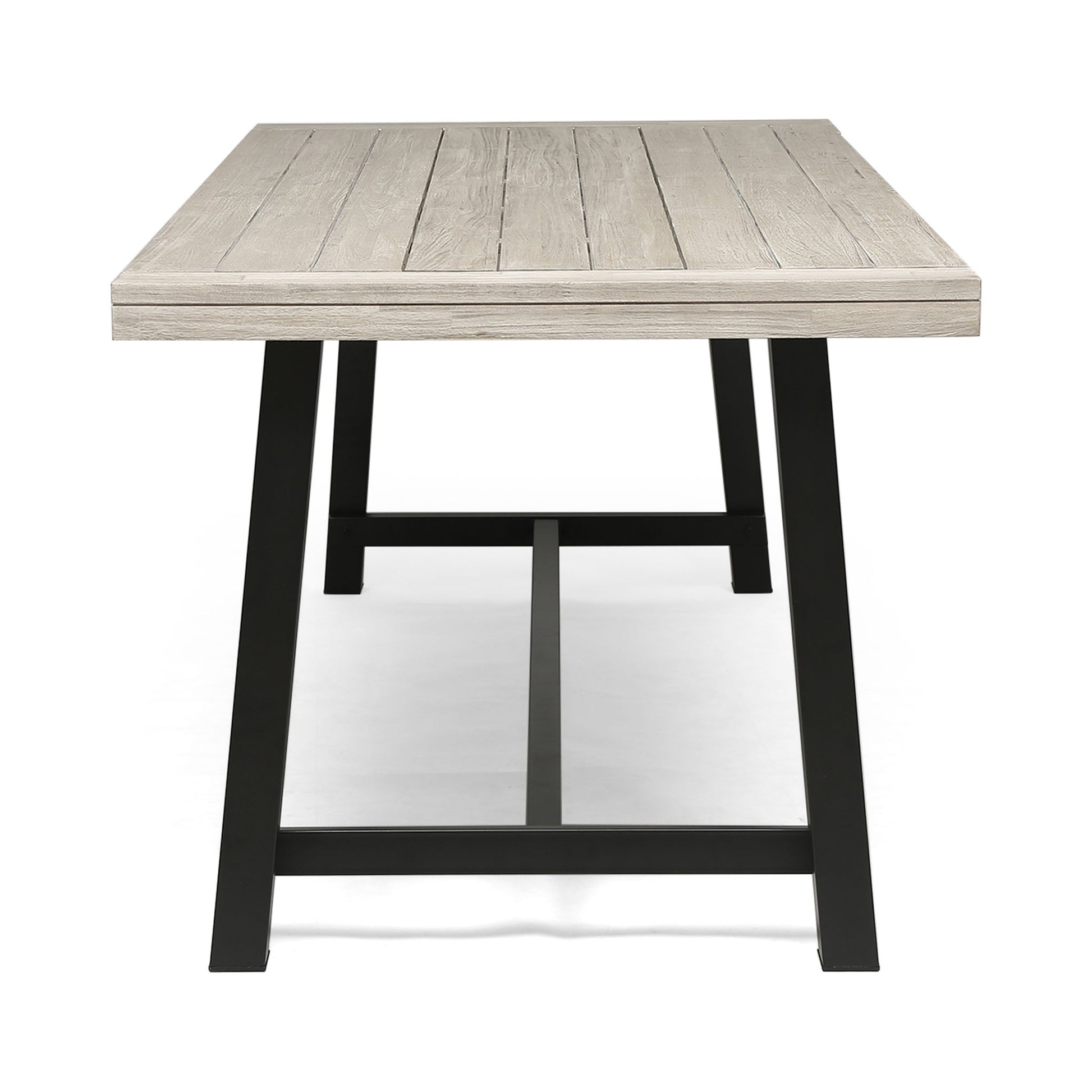 The Equilibrium Outdoor Dining Table features a light wooden slat top and black metal legs, shown from the short end against a white background.