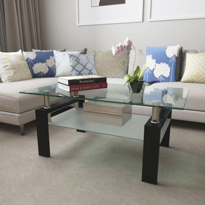 A modern living room featuring the Modern Rectangular Coffee Table With Tempered Glass Top, which holds books and a potted orchid, placed before a light sectional sofa with patterned blue, yellow, and white cushions.