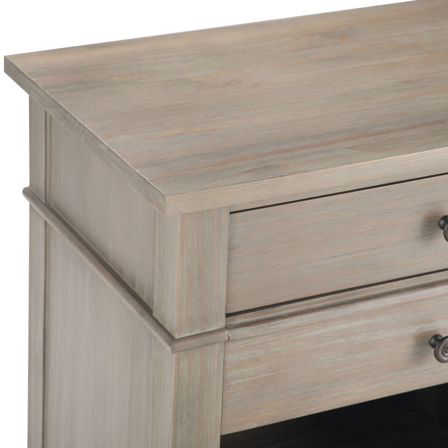 Close-up of the Carlton - Bedside Table, Handcrafted, showing its light weathered wood finish and a drawer with a metal knob handle.