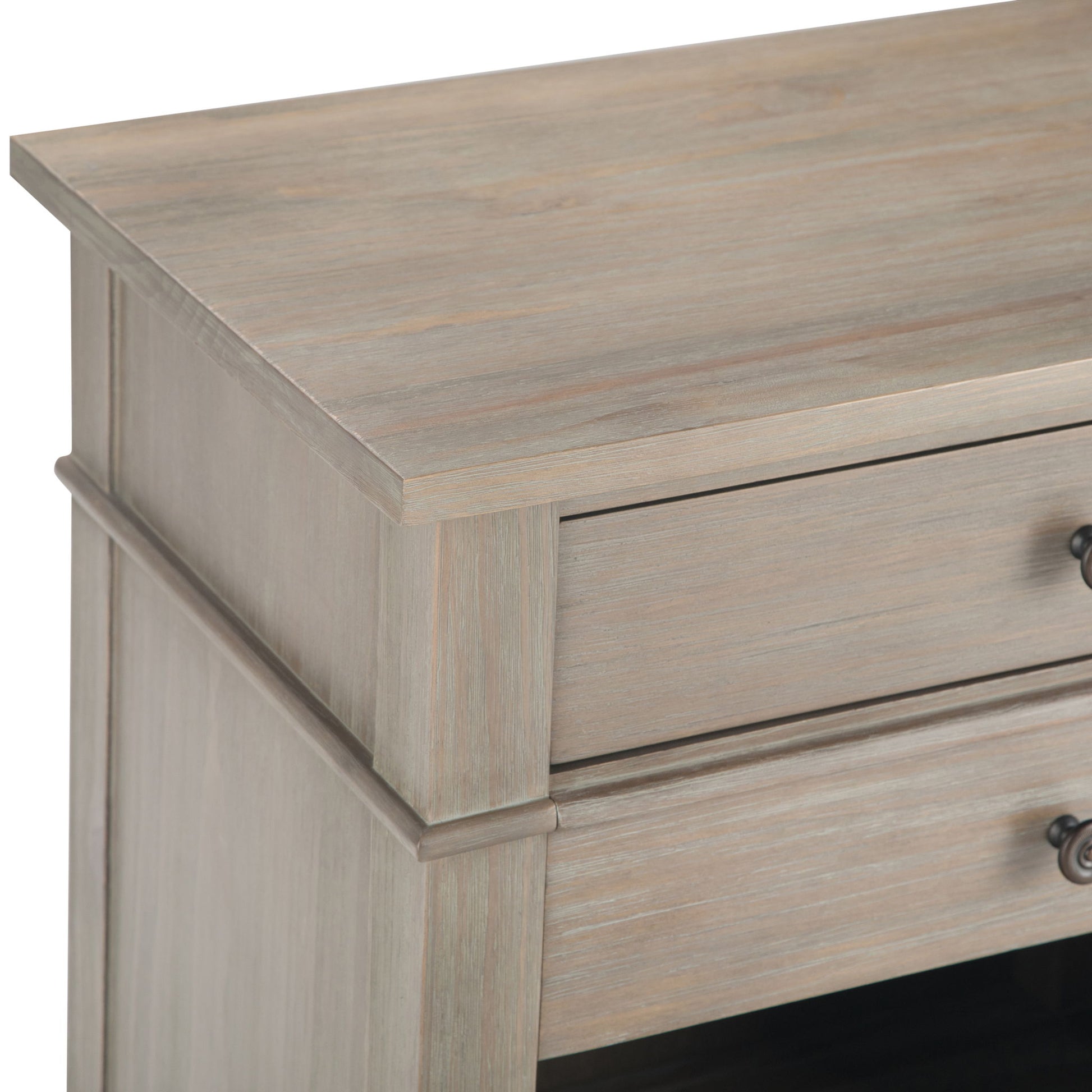 Close-up of the Carlton - Bedside Table, Handcrafted, showing its light weathered wood finish and a drawer with a metal knob handle.