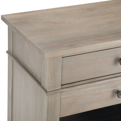 Close-up of the Carlton - Bedside Table, Handcrafted, showing its light weathered wood finish and a drawer with a metal knob handle.