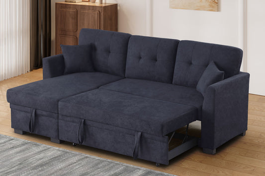 The Sectional Sofa Bed - Dark Blue is shown extended for sleeping in a modern living room with wood floors, a rug, and a cabinet in the background. Two cushions complete the L-shaped configuration.