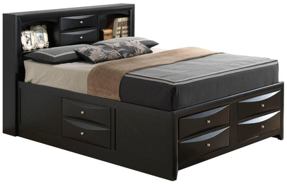The Marilla Storage Bed With Bookcase Headboard features built-in side and footboard drawers plus a headboard for books and décor, all in black wood, shown with neutral bedding and decorative pillows.