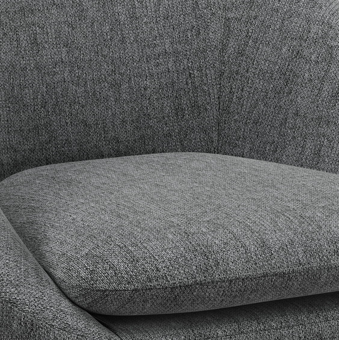 Close-up of the Redding - Upholstered Accent Chair, highlighting its gray fabric seat cushion, curved armrest, and backrest. The subtly textured upholstery looks soft and comfortable.