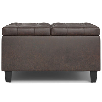 The Harrison Upholstered Coffee Table Storage Ottoman features dark brown tufted leather, a rectangular shape, and short black legs, shown from the front against a white background.