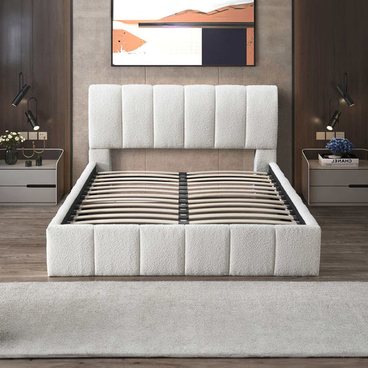 A modern bedroom showcases the Hilar - Elegant Design Platform Bed in white upholstery (shown without a mattress), complemented by matching nightstands, lamps, flowers, books, and abstract art above a wood-paneled wall.