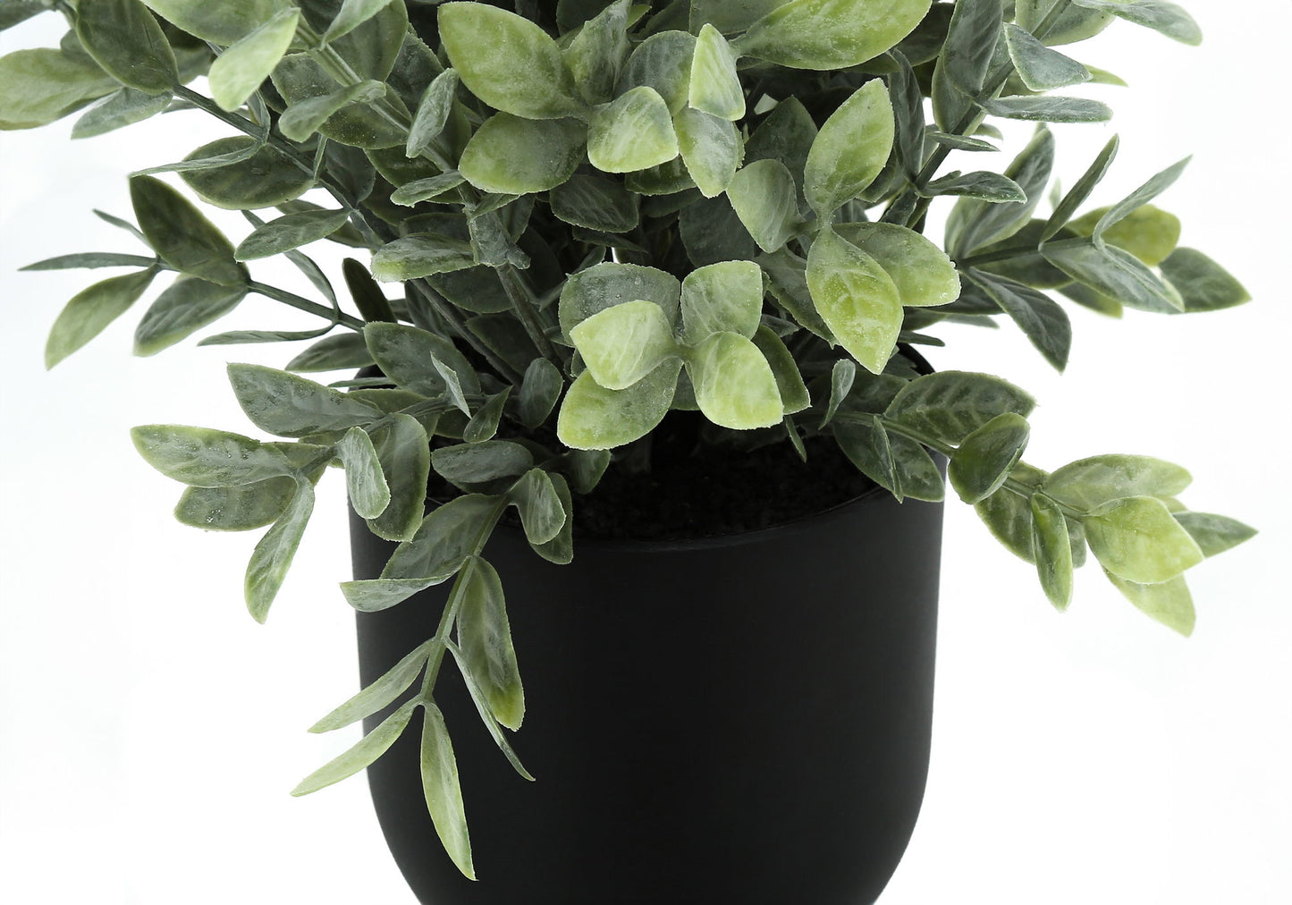 A close-up of the 11" tall artificial eucalyptus grass plant, featuring dense green foliage in a matte black pot, set against a white background. This decorative indoor faux greenery comes as a set of 2.