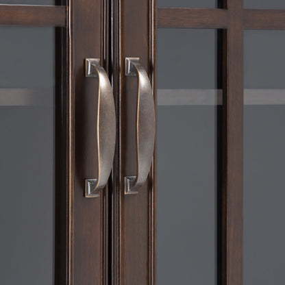 Close-up of two vertical metal handles at the center of the Connaught Tall Storage Cabinet in Dark Chestnut Brown, shown on its dark wooden doors with glass panels.