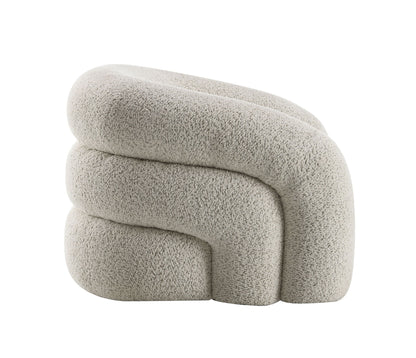 The Irma - Chair With Swivel in gray features a modern, sculptural design with chunky, rounded stacked forms and cozy, textured upholstery for a contemporary look.