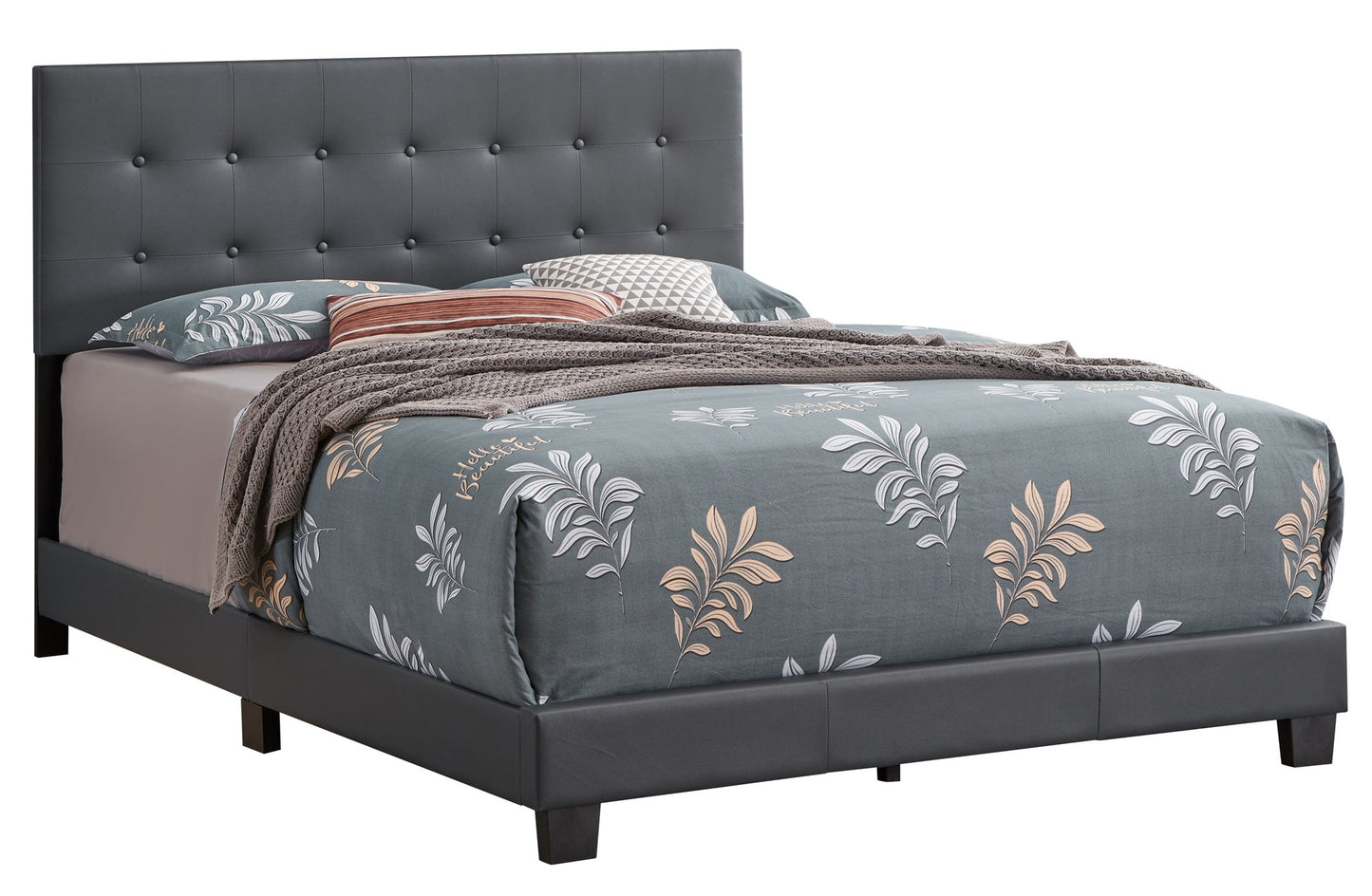 The Caldwell - Bed features a tufted dark gray upholstered headboard, gray floral-patterned bedding, a brown knit throw, and assorted pillows, all set against a white background.